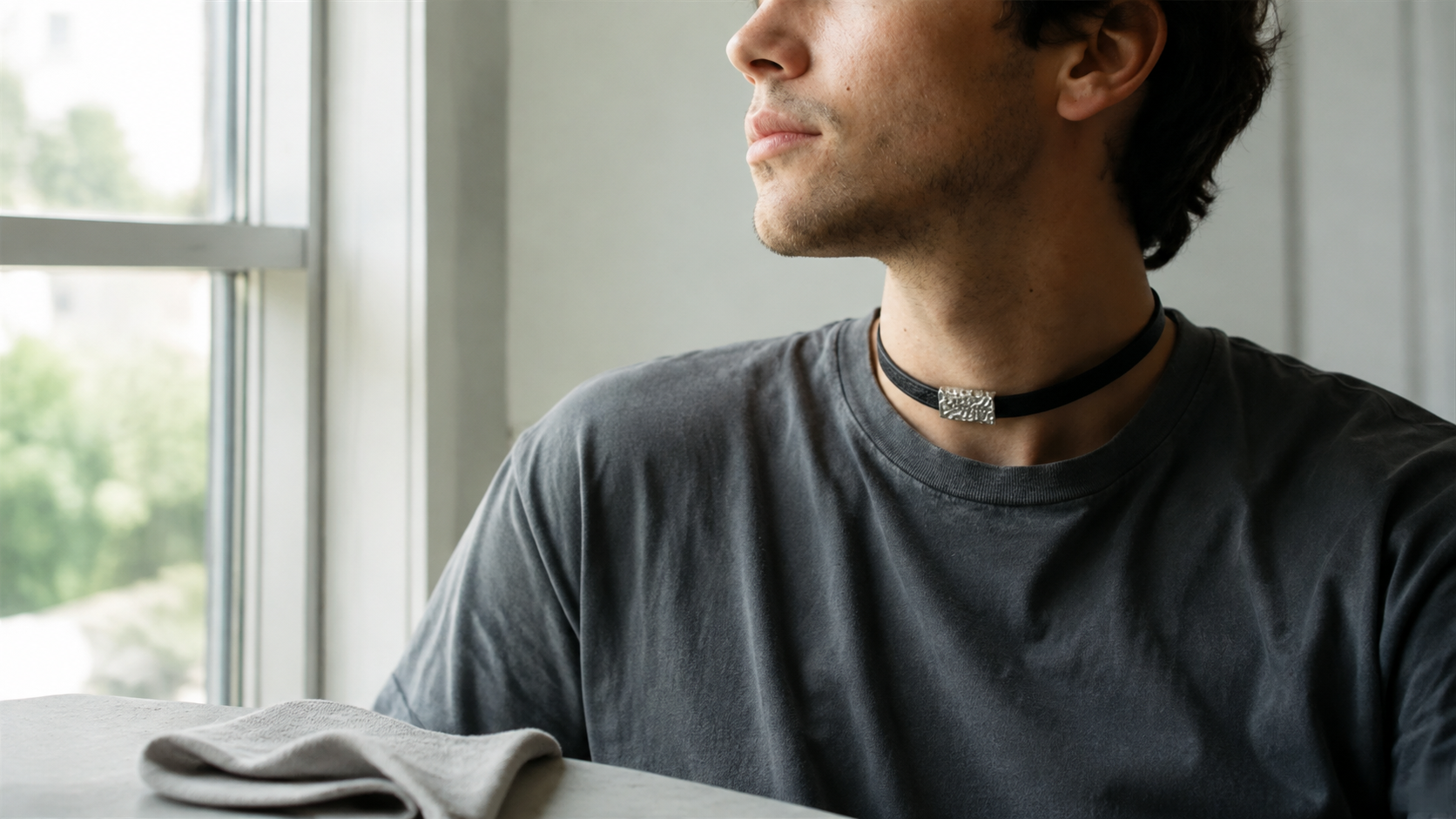 A discreet day collar worn naturally beside a soft care cloth
